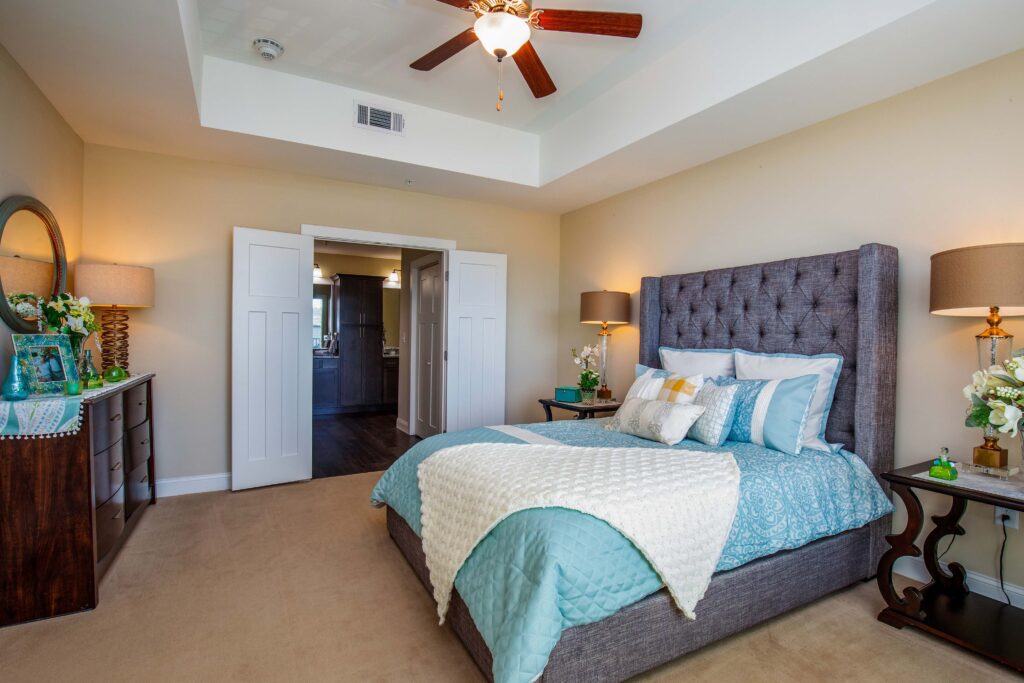 A spacious bedroom with a private bath at Celebration Village Acworth, a community with independent living.