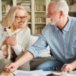 April 25 Events Page Image - Celebration Village Acworth Elderly man and his wife smiling and holding small dog